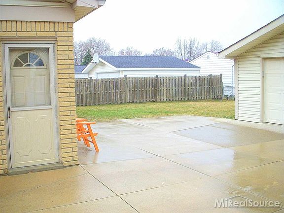 Spacious patio and full concrete drive.