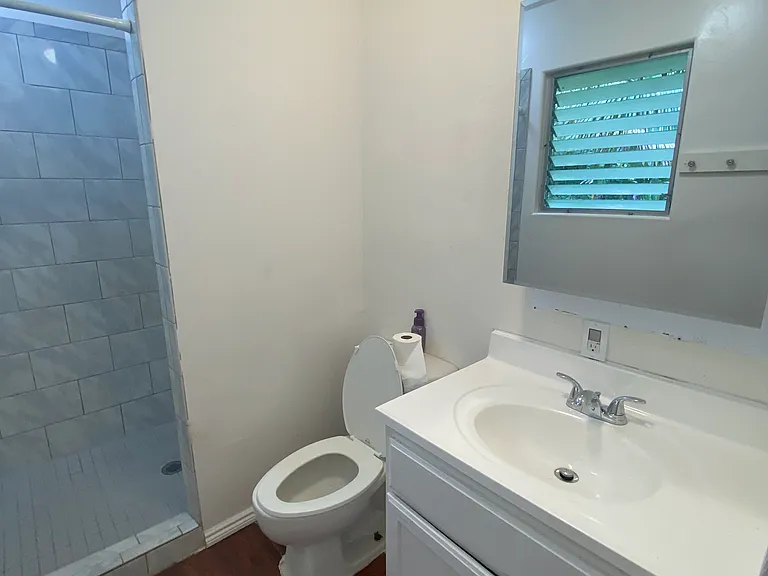 Newly installed sink and mirrored medicine cabinet. Note; the jalousie window seen is a reflection in the mirror.