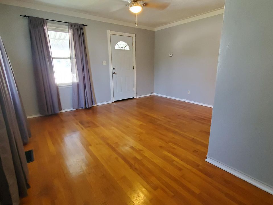 Living Room, looking towards front door. Window coverings are included with the rental.