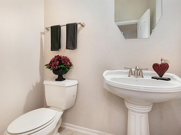 Half bath downstairs just off the entry.