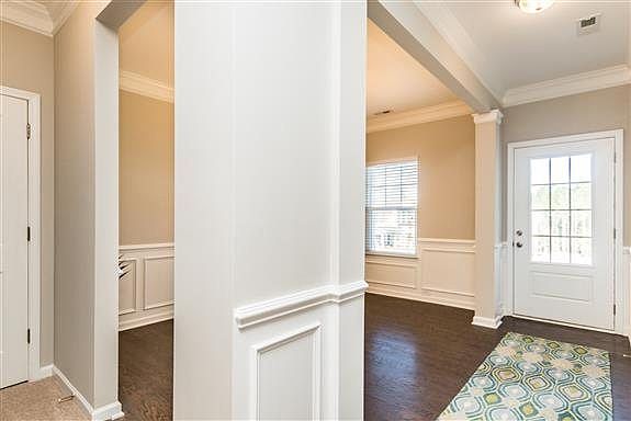MODEL HOME PICTURE- Formal Dining Space Includes Chair Rail & Wainscoting!