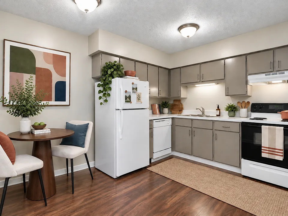 Warm and welcoming, the kitchen offers generous cabinetry and counter space alongside a charming dining nook. Rich wood-style flooring and a comfortable, functional layout create a space that feels both stylish and comfortable.