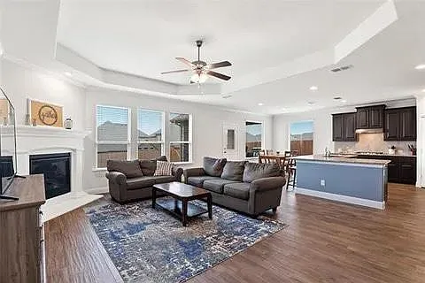 Wood tile throughout main areas. Open to kitchen and dining