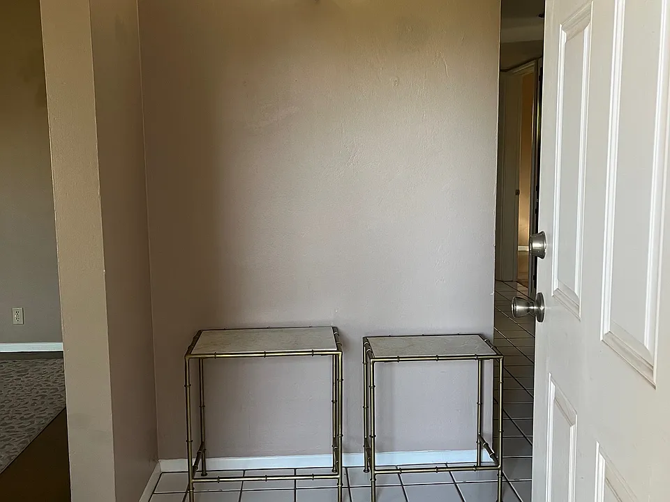 Stepping inside entryway; hallway on right and living room, dining, bonus room on left.