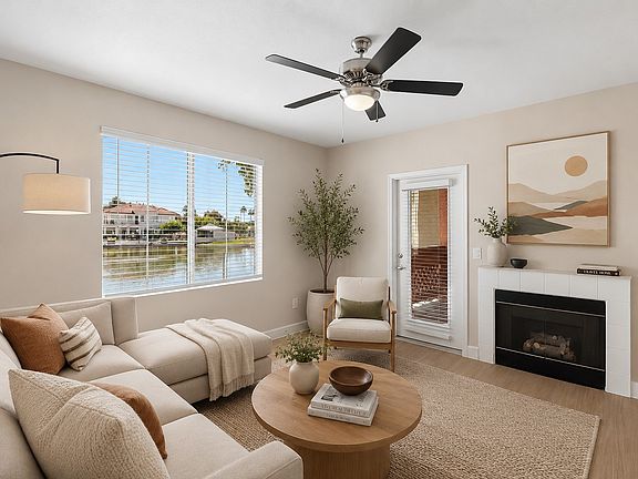 Step into the inviting living space at Serena Shores, where natural light dances through large windows, highlighting contemporary design and serene water views. Embrace comfort and styleschedule your visit today to explore your new home!
