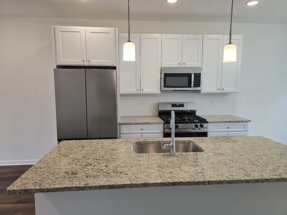 Kitchen with brand new stainless steel appliances and latest cabinetry with soft close