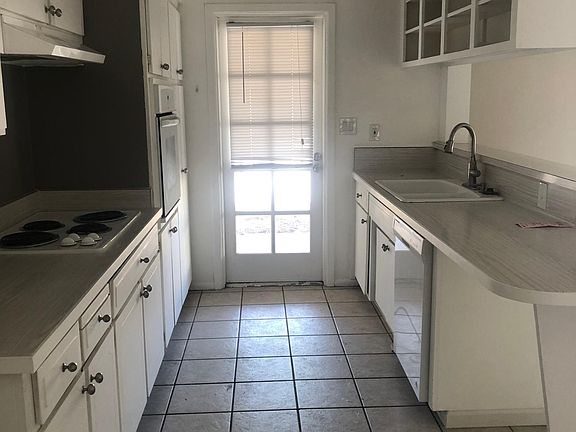 Kitchen with back door to enclosed laundry room and patio