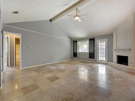Living room with 18" Travertine tile and fireplace.