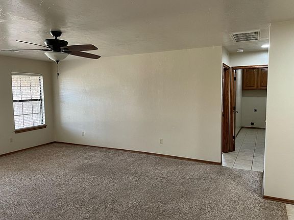 Masterbed room to the left off of the short hallway & utility room at entry from garage area to the right