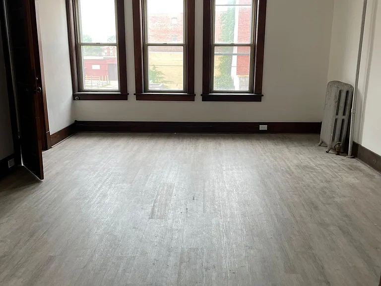 spacious living room with plenty of natural light, storage closet and ceiling fan