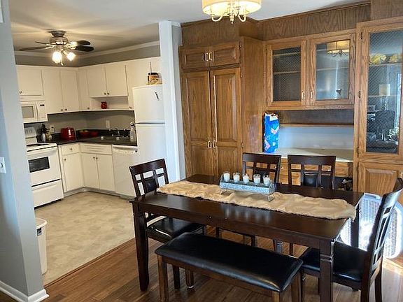 Dining area and kitchen. Washer dryer unit in cabinet on left