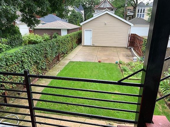 back deck large fenced in yard and patio with garage space off storage