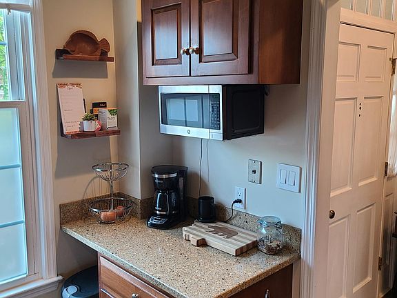 Kitchen, off of the Entryway/Foyer. The two floating shelves on the wall by the window convey with the rental.