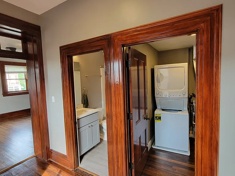 Spacious hallway outside bedroom has bathroom and laundry room access