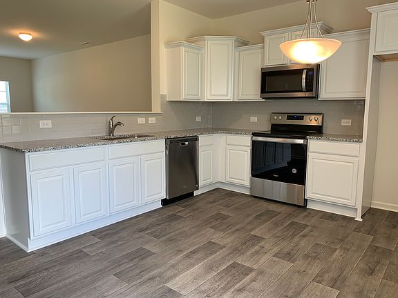The kitchen opens to the Great room with an eat-in area.
