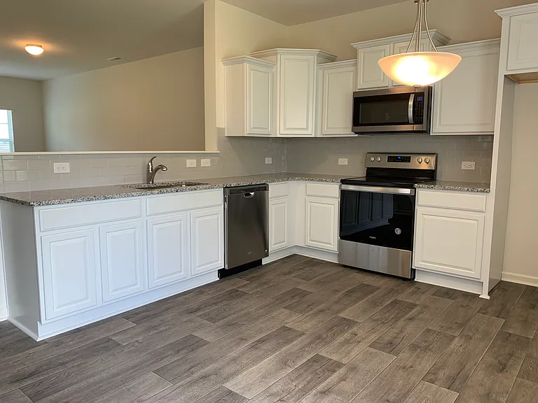 The kitchen opens to the Great room with an eat-in area.