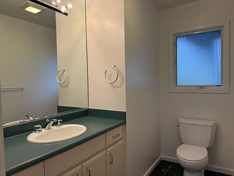 Powder room adjacent to the kitchen and the media room.