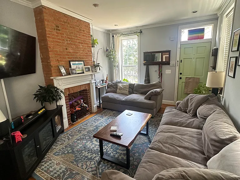 Living room with historic, original fireplace and mantel, 2024