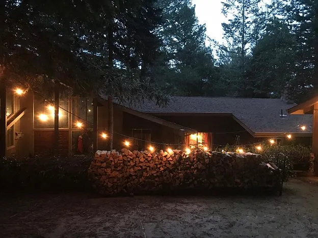 Miners lights over firewood and Main house at night