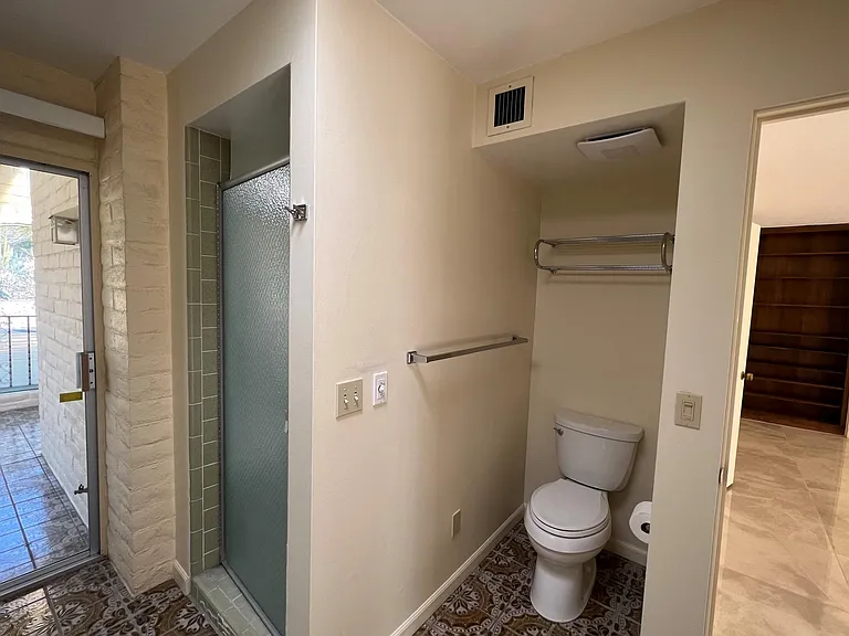 Main bathroom with door to walk-in shower and bathtub.
