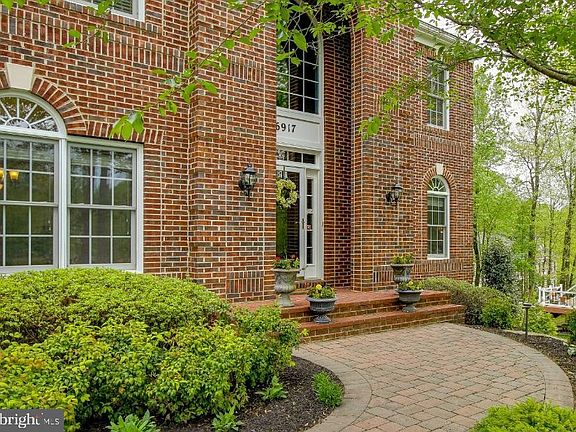 Brick walkway leads to covered  brick entryway
