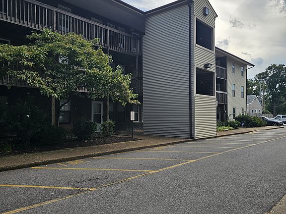 Convenience at your doorstep. A view from the community lot looking toward the Chesapeake Blvd entrance, offering quick and easy access to your daily commute, local dining, and shopping.