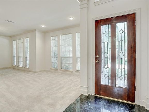 As you enter the foyer thru a lead glass front door you'll find soaring ceilings, and the formal living and dining room is to your right.  Rich carpeting, tons of windows and ample space highlight the front of the house.  The formals boost of recessed lighting, crown molding and a chandelier.