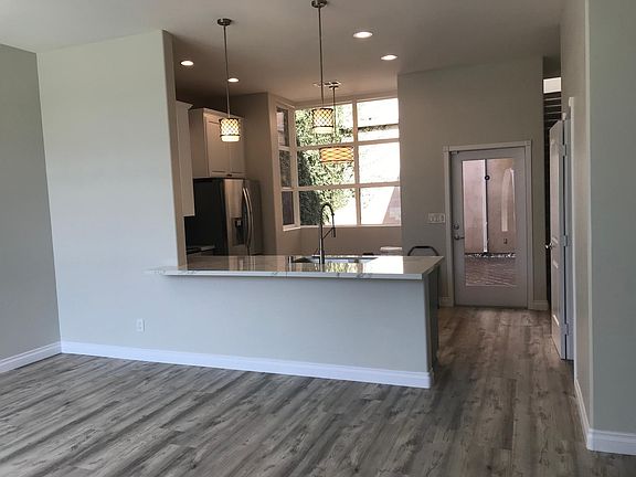 Kitchen has small nook for dining with beautiful tall window looking out to your private courtyard