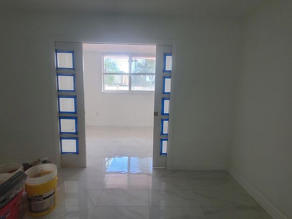 Living room with Den through doble glass doors. Den is 8x12.