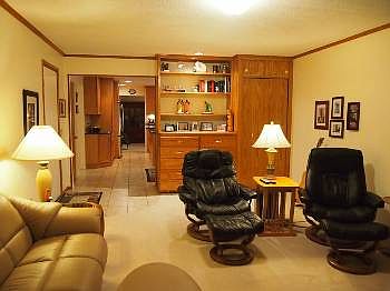 Family room with cabinetry leading into the kitchen