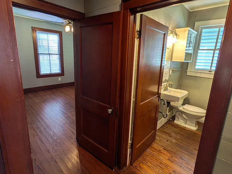 Hallway looking into bathroom and rear bedroom