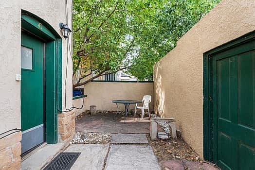Entry door and adjacent concrete patio courtyard, which is a secluded and quiet space.