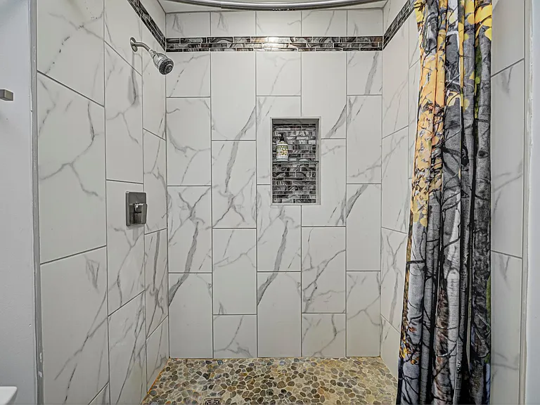 Shower with ceramic tiles in downstairs full bath