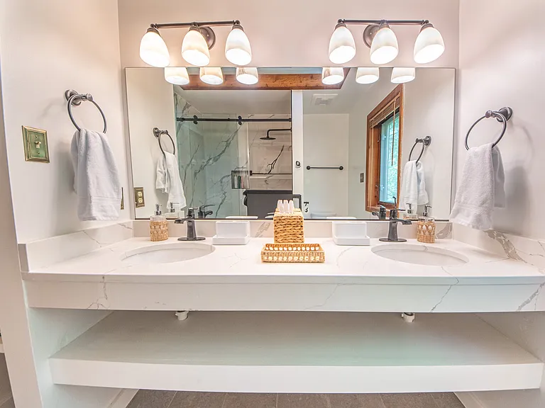 Guest bath with double sinks and quartz counter top.
