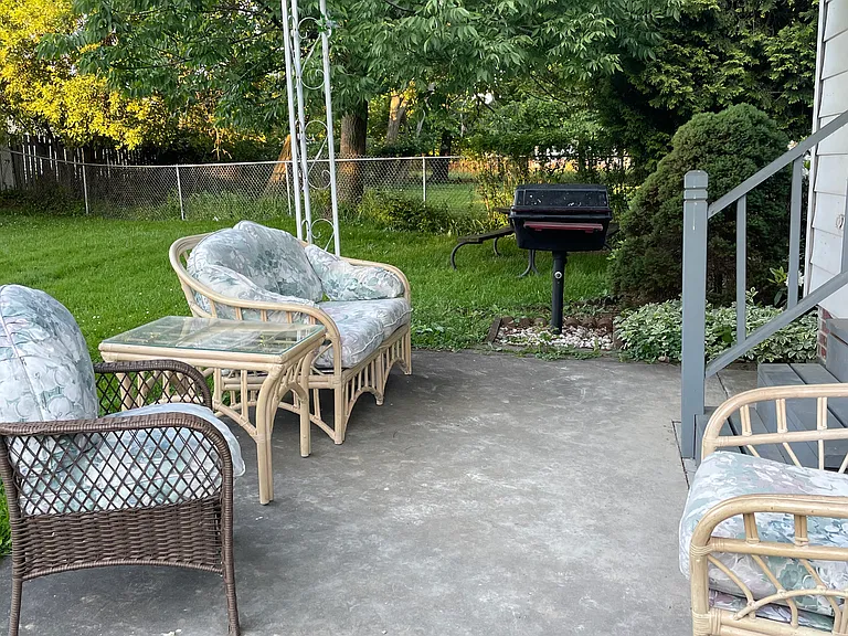 Patio furniture included, with freshly laundered cushions.