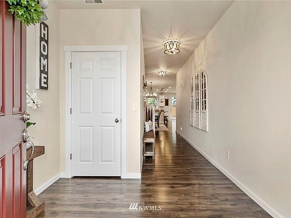 Enter to soft inviting colors, a laminate floor and elegant light fixtures. The closet under the stairs is to the left