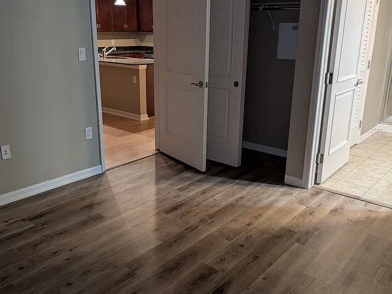 From far corner of the bedroom. You see the kitchen to the left, a closet and then entry into the ensuite bathroom