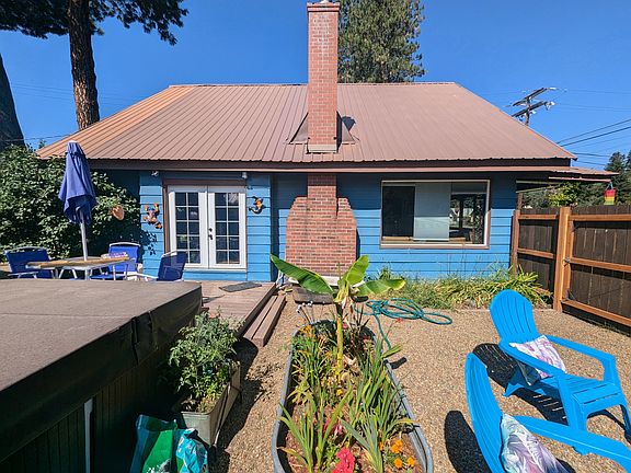 Side Yard. Raised deck, gravel seating area, hot tub, mature gardens. 8' access gate.