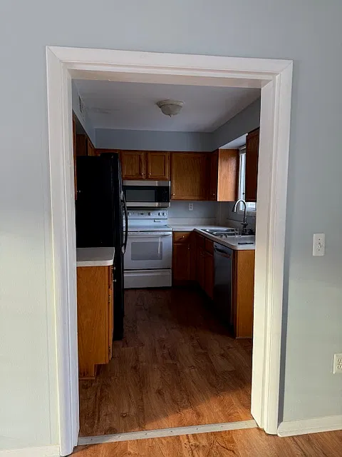 Kitchen. To the right, there is a door that leads out to the back patio.