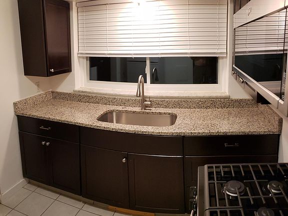 granite counter with large single stainless sink
