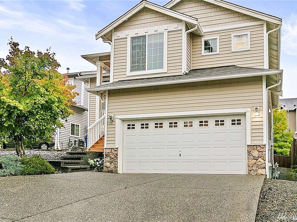 Front view of the house. ample car parking space in front of side to side garage