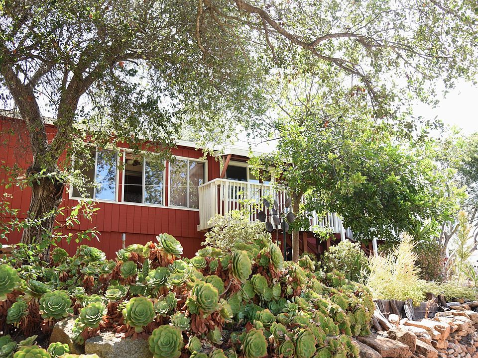 Outside front of the house. Two small balconies on the front.