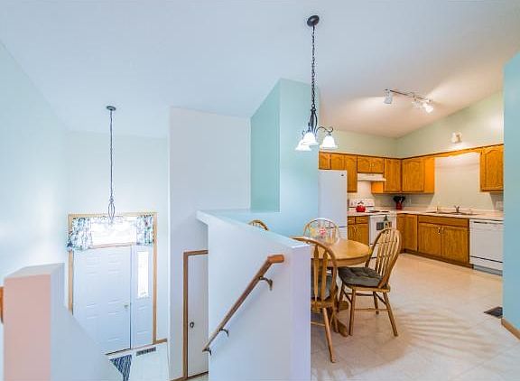 Open floor plan allows easy flow from dining/living area to kitchen. New light fixtures in the foyer and kitchen.