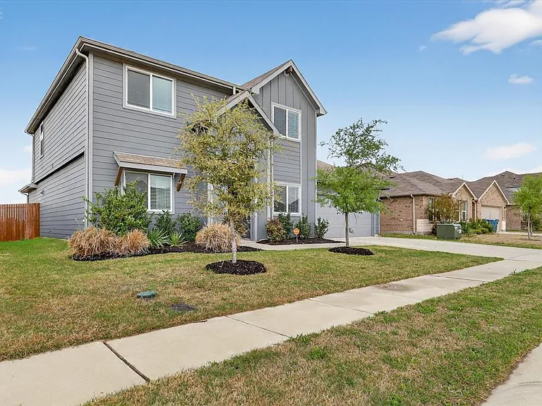 Two-story residence featuring gray horizontal siding and vertical board and batten accents