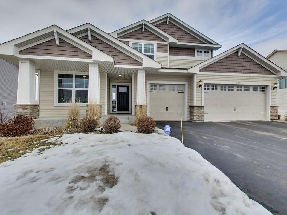 Welcome home to 12480 76th St NE located on a premier lot in Martin Farms. Great curb appeal with pillars, stone and front porch.