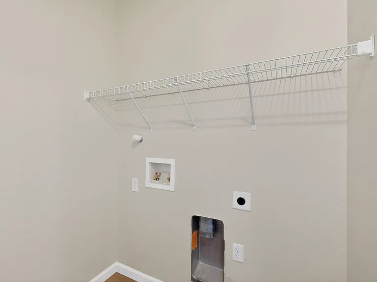 The laundry room off of the garage include washer and dryer hook ups to accommodate your appliances. Dryer hook ups for electric dryer only.