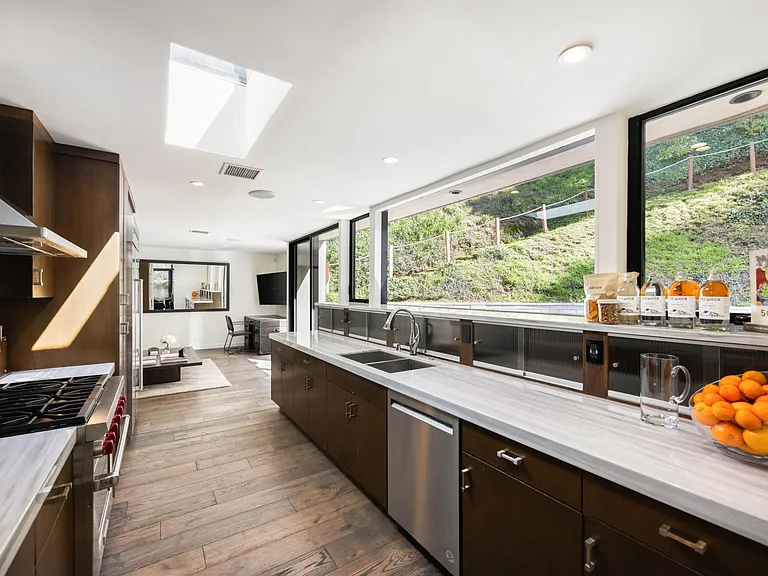 Brighten your culinary endeavors with natural light streaming through the kitchen windows, creating an inspiring atmosphere.