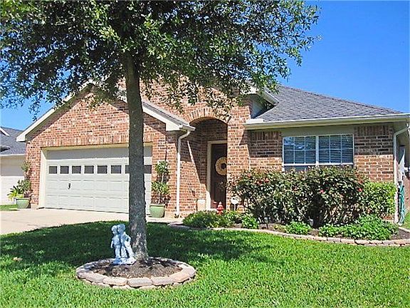 Lush landscaping and thick green grass gives this home instant curb appeal.