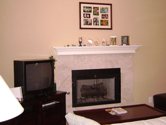 View from the front door of the living room; gas burning fireplace