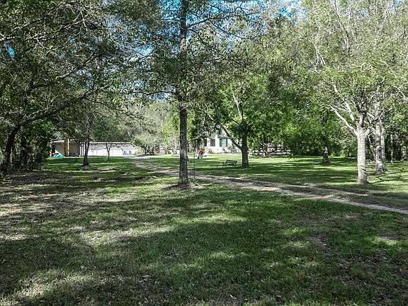 The acreage has pecan trees, and some fruit trees.